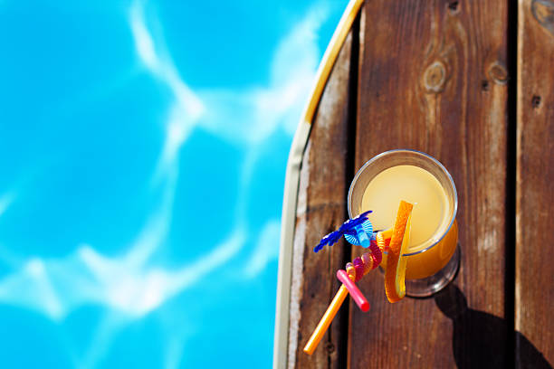 istock Refreshing coctail near swimming pool on vacation 497494795