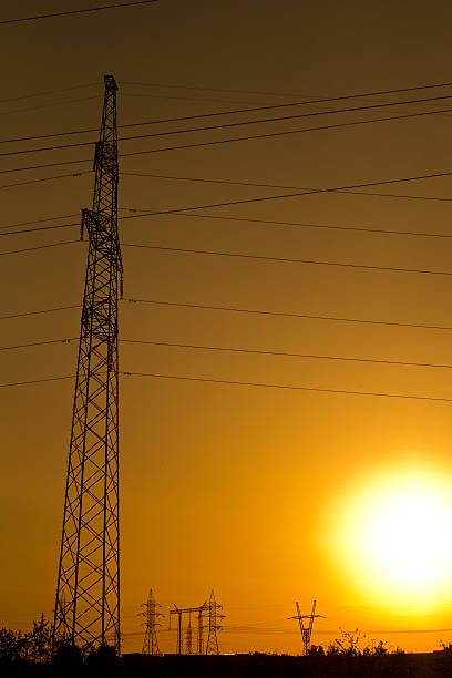 istock High-voltage tower and wires on sunset background 497495677