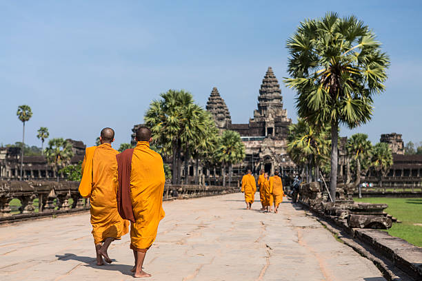 Group of Buddhist monks walking in Angkor Wat in Cambodia stock photo
