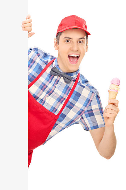 istock Male ice cream seller posing behind panel 497509693