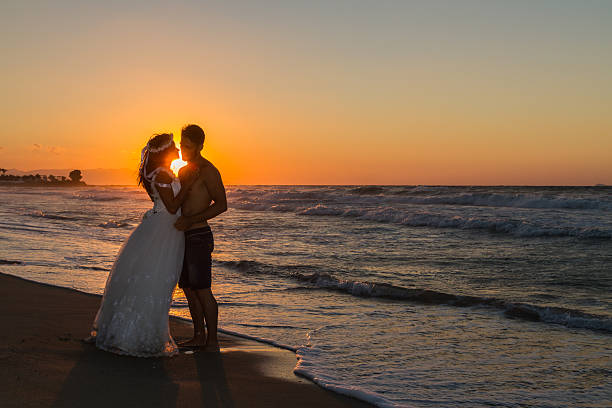 istock Just married young couple on a hazy beach at dusk 497510226