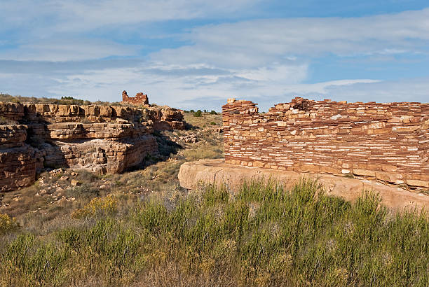 Lomaki Pueblo Dwelling Lomaki Pueblo, meaning the "Beautiful House", is located on Antelope Prairie in the plains between the Painted Desert and the San Francisco Peaks of Arizona. Nearly a thousand years ago natives inhabited this area which is so dry and windy it would seem impossible to live. It was here that they built pueblos, harvested rainwater, grew crops and raised families. Today the remnants of their villages dot the landscape. Wupatki National Monument was established in 1924 to preserve this cultural heritage. The monument is located off US Highway 89 near Flagstaff, Arizona, USA. chinle formation stock pictures, royalty-free photos & images