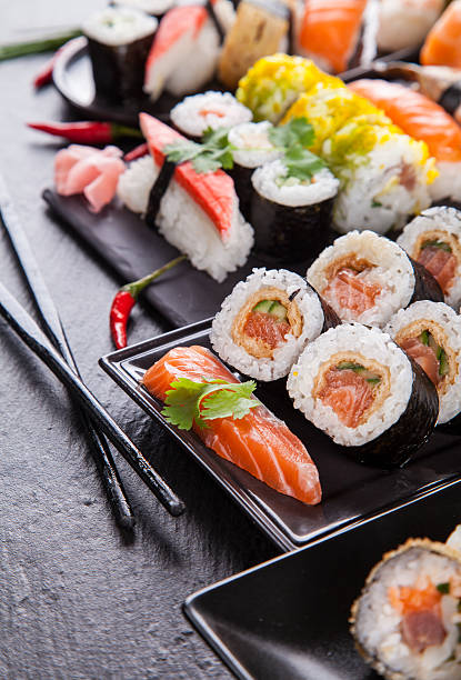 istock Delicious sushi pieces served on black stone 497510791