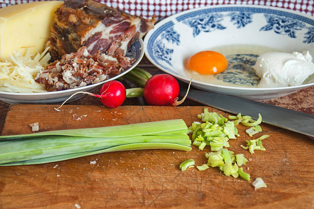 Preparing of scrambled eggs with bacon and onion
