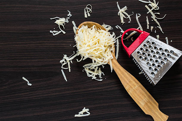 istock Grated cheese in the spoon and grater 497511528