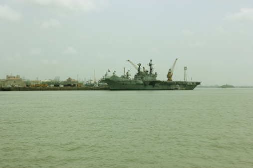 Mumbai, India - June 3, 2014: INS Viraat (R22) visits Mumbai port in Mumbai, India. INS Viraat (R22) is a Centaur-class aircraft carrier in service with the Indian Navy. INS Viraat is the flagship of the Indian Navy, the oldest carrier in service and one of three aircraft carriers based in the Indian Ocean Region.