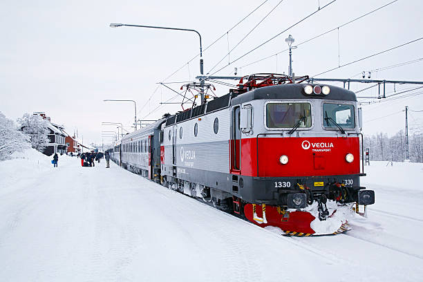 Kiruna, Sweden - November 12, 2007: The temperature hovers well below zero as a Veolia passenger train stops at the snow-covered Kiruna railway station in Sweden’s Arctic Circle.  Kiruna Station has since been moved to a new location and the railway lines re-aligned, in preparation for the expansion of the town’s LLKAB iron ore mine.  