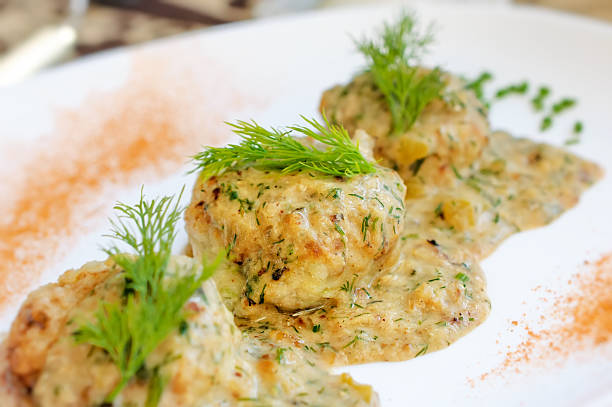 istock Meatballs served in a dill sauce on a white plate. 497513032