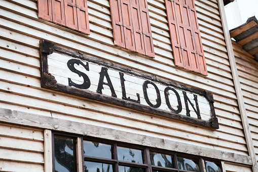 Saloon sign on building facade, nobody