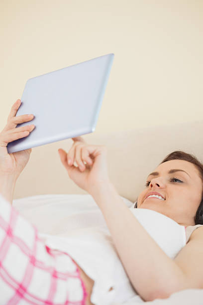 istock Smiling girl holding a tablet pc 497514839