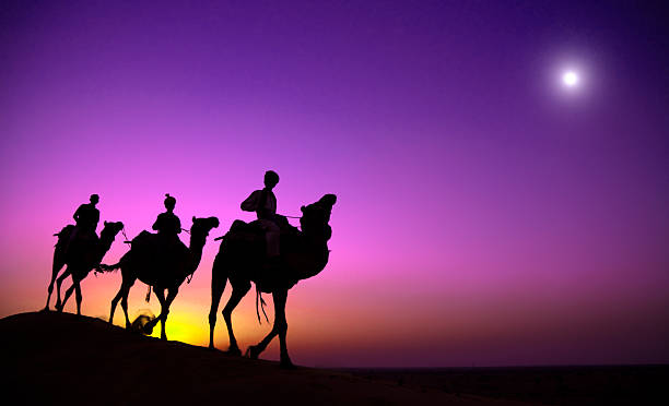 istock Indigenous Indian Man Riding Through Desert Camel Concept 497516666