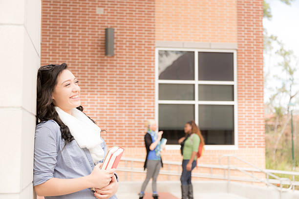 istock Education: Mixed-race college student on campus. Friends background. 497519864