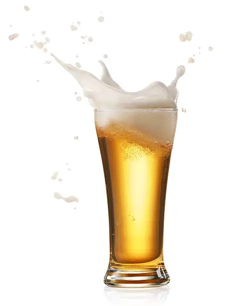 glass of splashing beer isolated on white