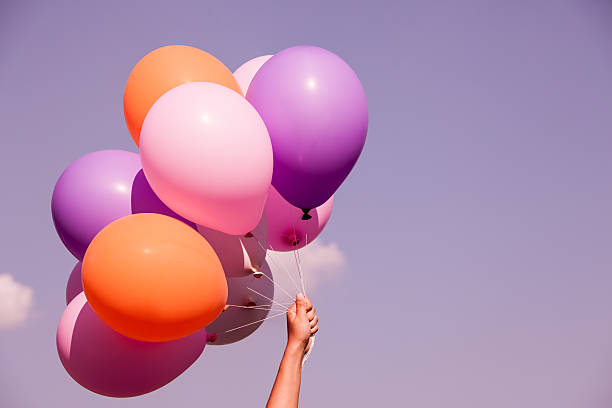 Colorful balloons on sky background in purple color tone stock photo