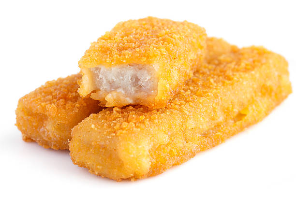 Fried fishfingers on white surface. Fried fishfingers on white surface. fish stick stock pictures, royalty-free photos & images