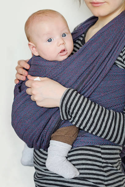 Baby in sling 3 month old baby in sling baby carrier stock pictures, royalty-free photos & images