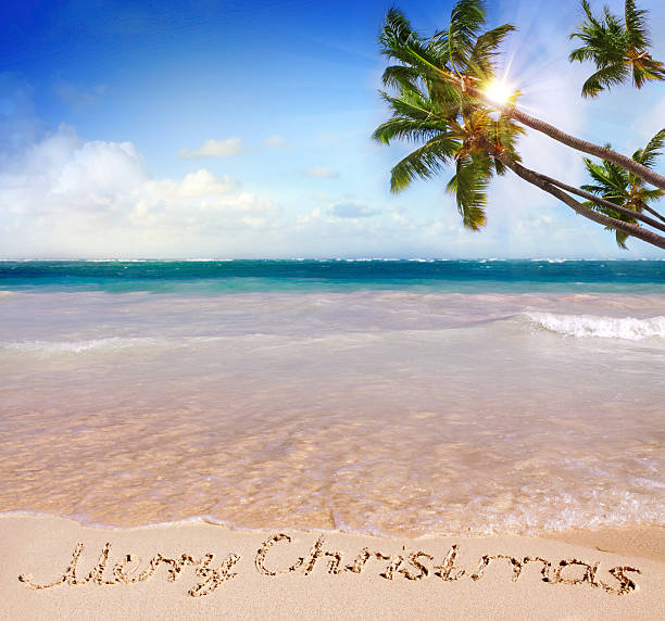 istock Merry Christmas written on tropical beach . 497528283