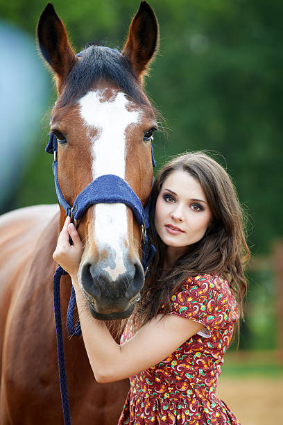 istock Beautiful young woman with a horse 497534120
