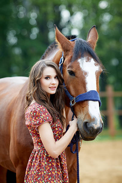 istock Beautiful young woman with a horse 497534236