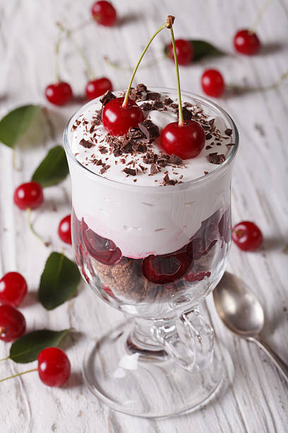 istock Gourmet cherry dessert in glass close-up on the table. vertical 497535822