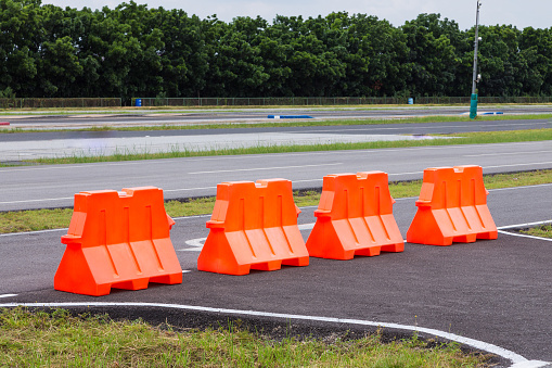 Orange plastic barrier lined up in rows