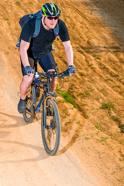 istock active man on a bicycle wearing a helmet on road 497538036