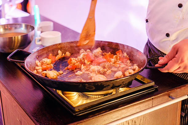chef making paella stock photo