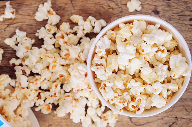 istock Popcorn in paper cups on wooden surface. Top view 497539660