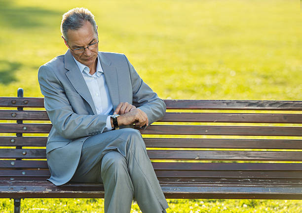 istock Mature businessman checking time on his wristwatch. 497540838