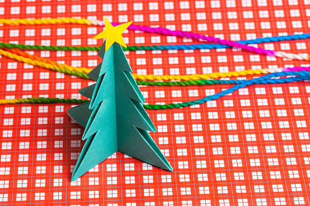 istock Christmas tree on white isolated origami. 497540930