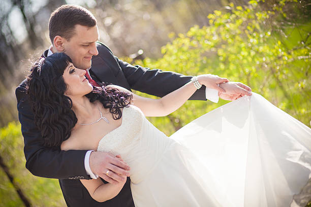 istock The groom and the bride in a green park 497541984