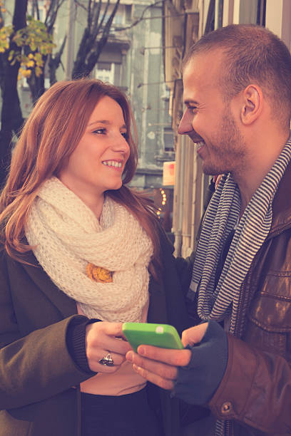 istock Couple in love using cellphone outdoors. 497542326