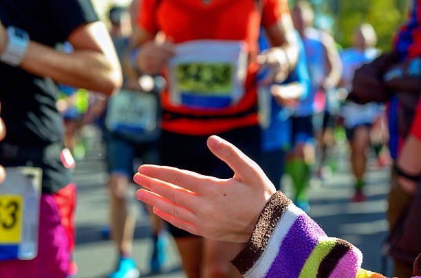 istock Marathon running race, support runners on road 497543582