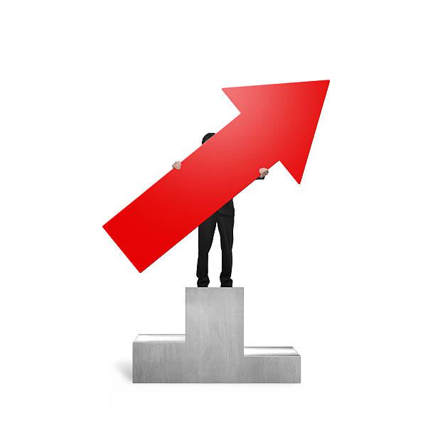 istock Man holding red arrow up on podium 497543760