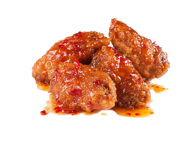 Spicy chicken wings - Stock image fried breaded chicken wings drenched in hot sauce on a white background, stock image buffalo iowa stock pictures, royalty-free photos & images