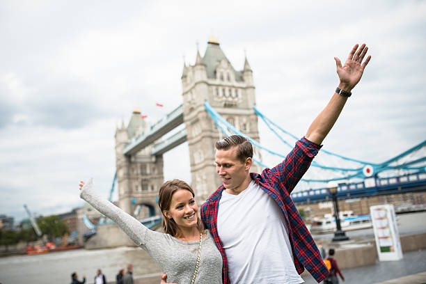 istock Couple portrait at tower bridge with arm raised 497545264