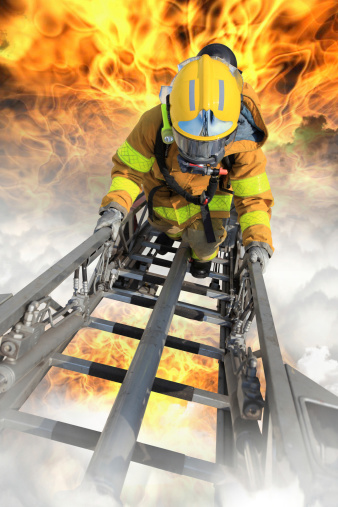 Firefighter ascends upon a one hundred foot ladder.