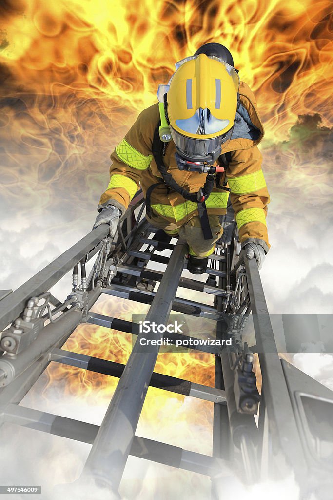 Firefighter ascends upon a one hundred foot ladder. Firefighter Stock Photo