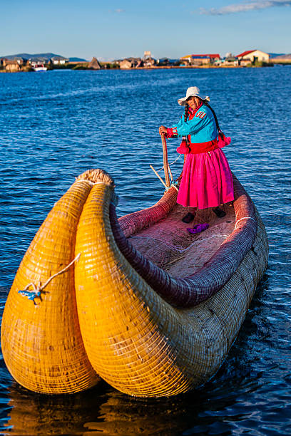 istock Peruvian woman sailing between Uros floating islands, Lake Tititcaca 497547073