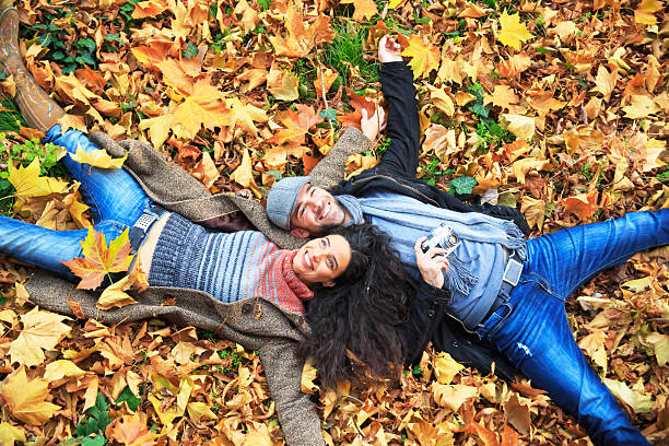 istock Smiling couple lying down on leaves 497547846