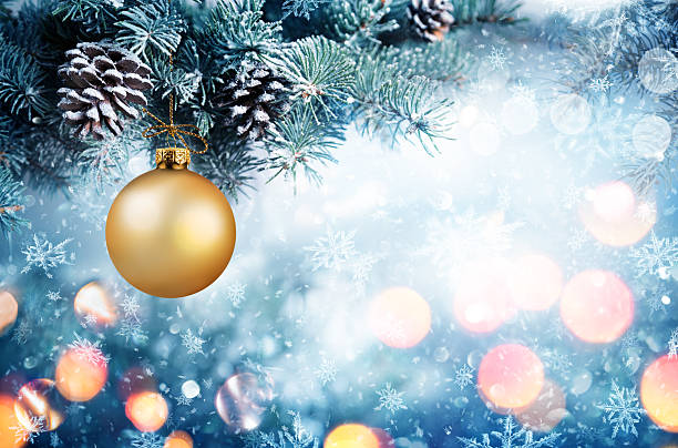 istock Golden Bauble Hanging Fir Branch With Snowfall 497548488