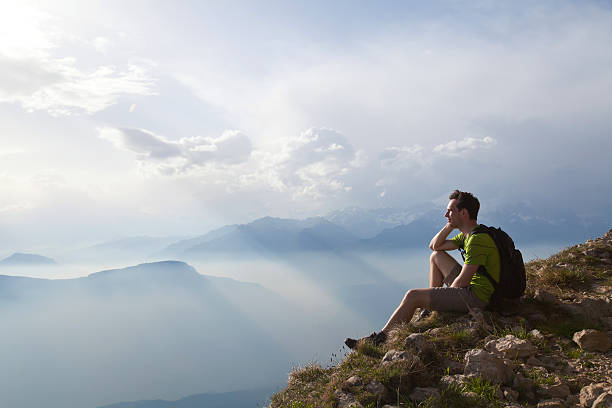 istock hiker traveler enjoying panoramic view of mountains 497548576