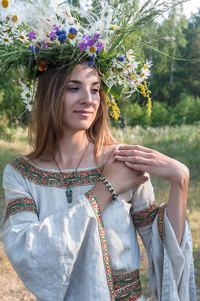 istock Young beautiful woman with flower wreath 497548753
