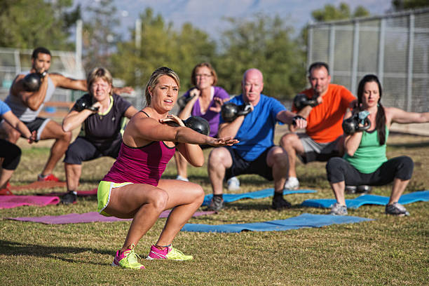 Mixed Group Doing Boot Camp Exercise Mixed group of people doing a boot camp exercise class fitness boot camp stock pictures, royalty-free photos & images