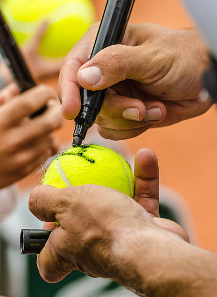 Tennis player signs autograph after win stock photo