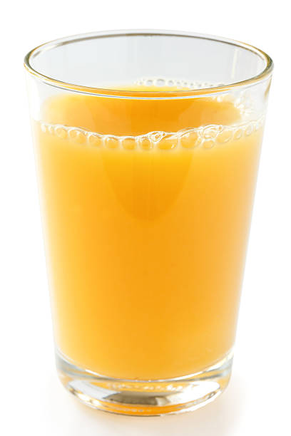 istock Single glass of orange juice on a white surface. 497549767