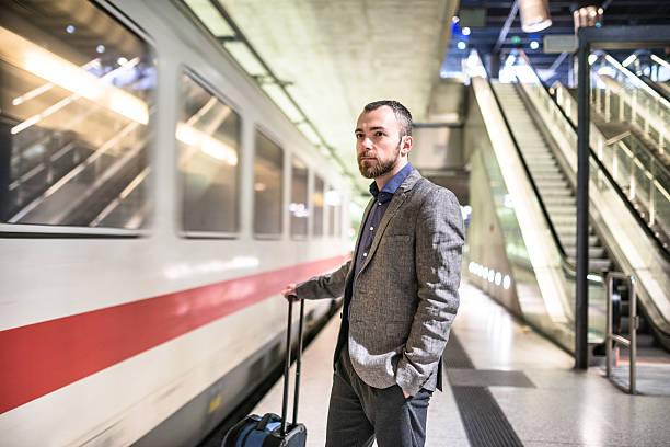 istock businessman waiting the train platform at the station 497562866