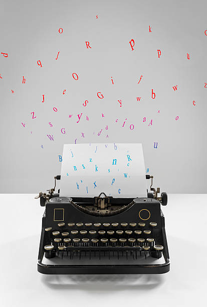 istock Old vintage black typewriter, multicolored flying letters, sheet of paper 497564548