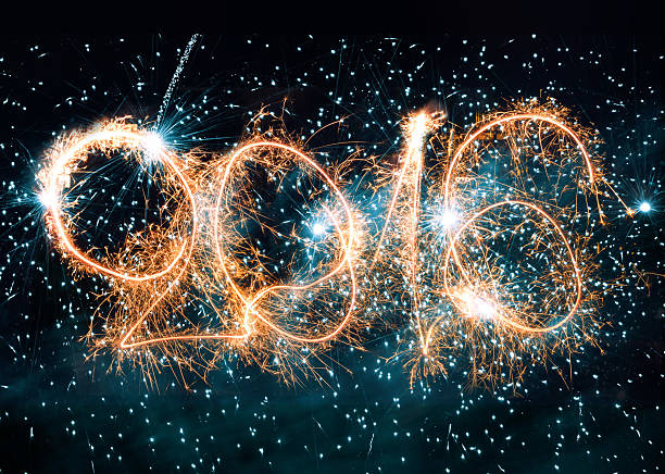 istock 2016 sparks number on illuminated black background 497566198