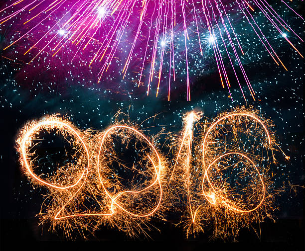 istock number 2016 sparks on purple fireworks background 497567422